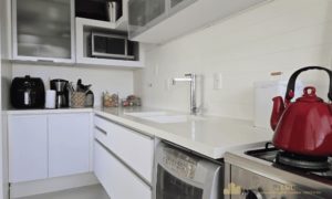 Detalhes dos armários e eletrodomésticos da cozinha planejada.