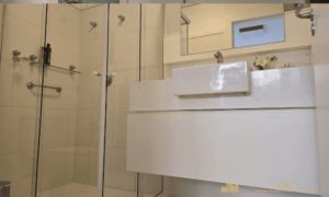 Banheiro social/suíte com cuba de apoio e acabamento clean.